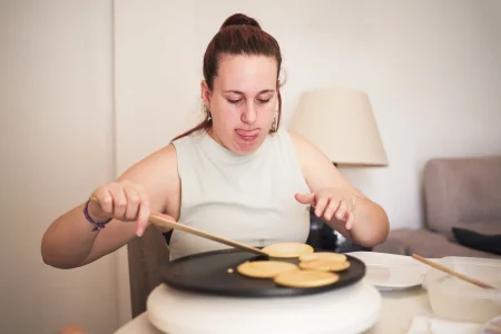 Woman cooking pancakes at home